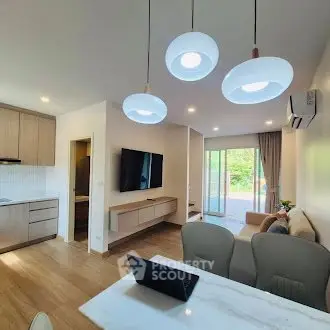 Modern living room with open kitchen and stylish lighting