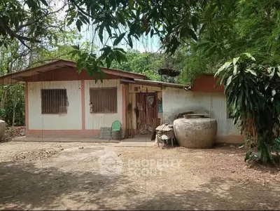Charming rustic house surrounded by lush greenery, perfect for nature lovers seeking tranquility.