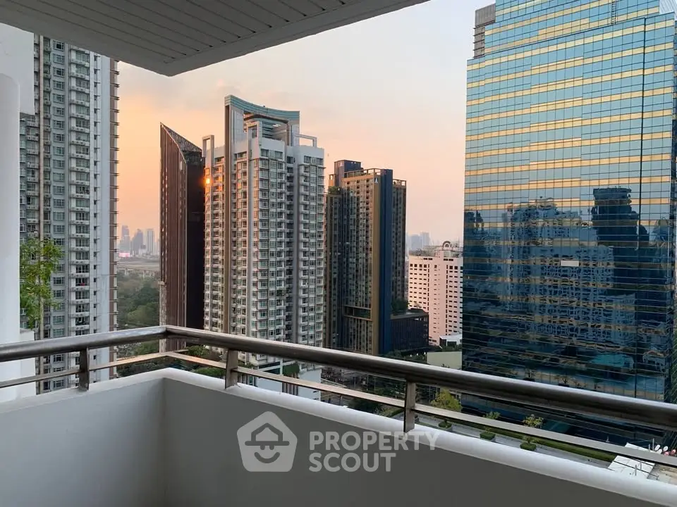Stunning urban balcony view with modern skyscrapers at sunset, perfect for city living enthusiasts.