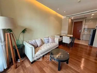 Elegant living room with modern decor and open kitchen layout in luxury apartment.