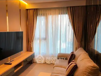 Cozy living room with modern decor and large window with elegant curtains