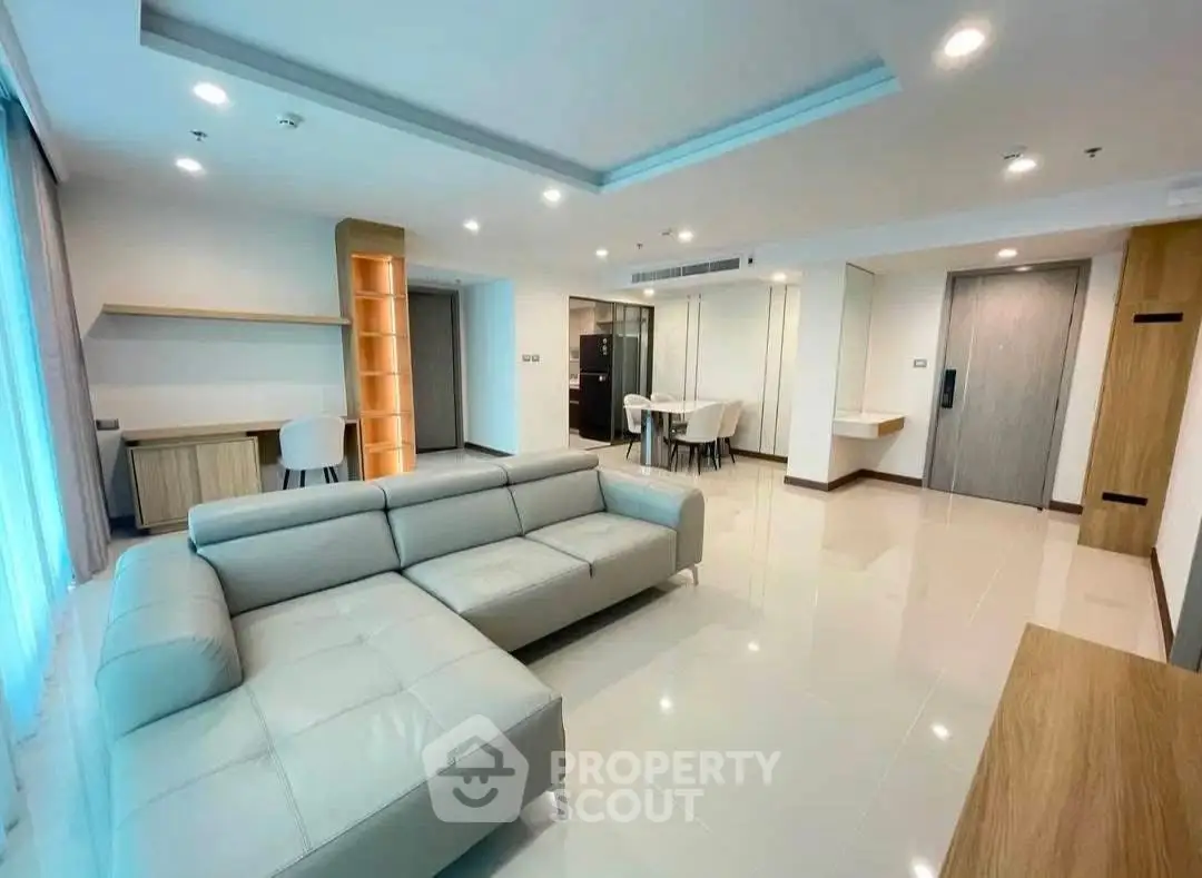 Spacious modern living room with sleek furniture and open layout in a luxury apartment.