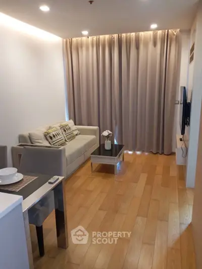 Modern living room with cozy sofa and wooden flooring in a stylish apartment.