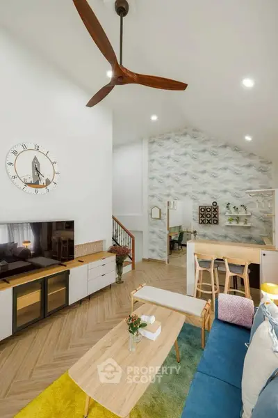 Modern living room with stylish decor, high ceiling, and open layout