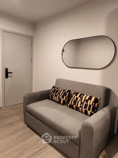 Cozy small living room with modern sofa and stylish mirror