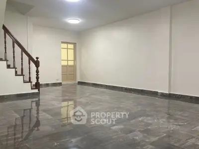 Spacious empty living room with marble flooring and staircase