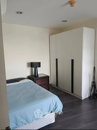 Cozy bedroom with modern wardrobe and stylish lamp, perfect for restful nights.