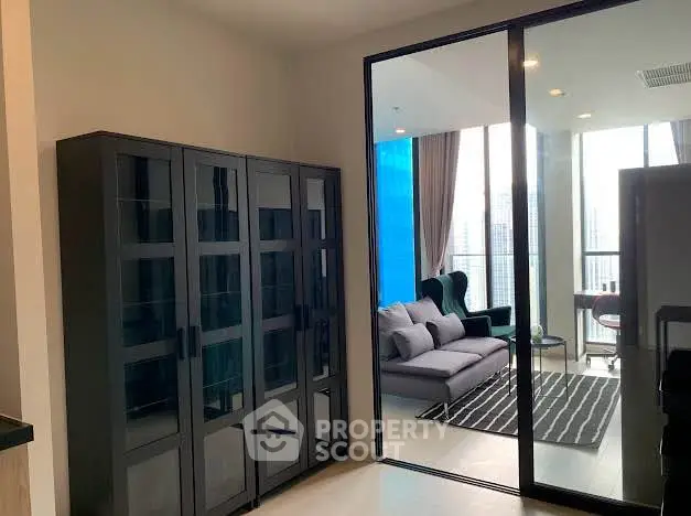 Modern living room with glass cabinet and balcony view in high-rise apartment
