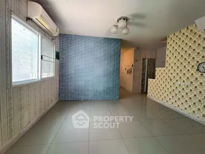 Spacious unfurnished room with unique wallpaper and tiled flooring