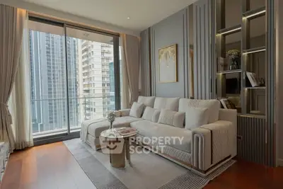 Luxurious modern living room with elegant decor and city view balcony in high-rise apartment.