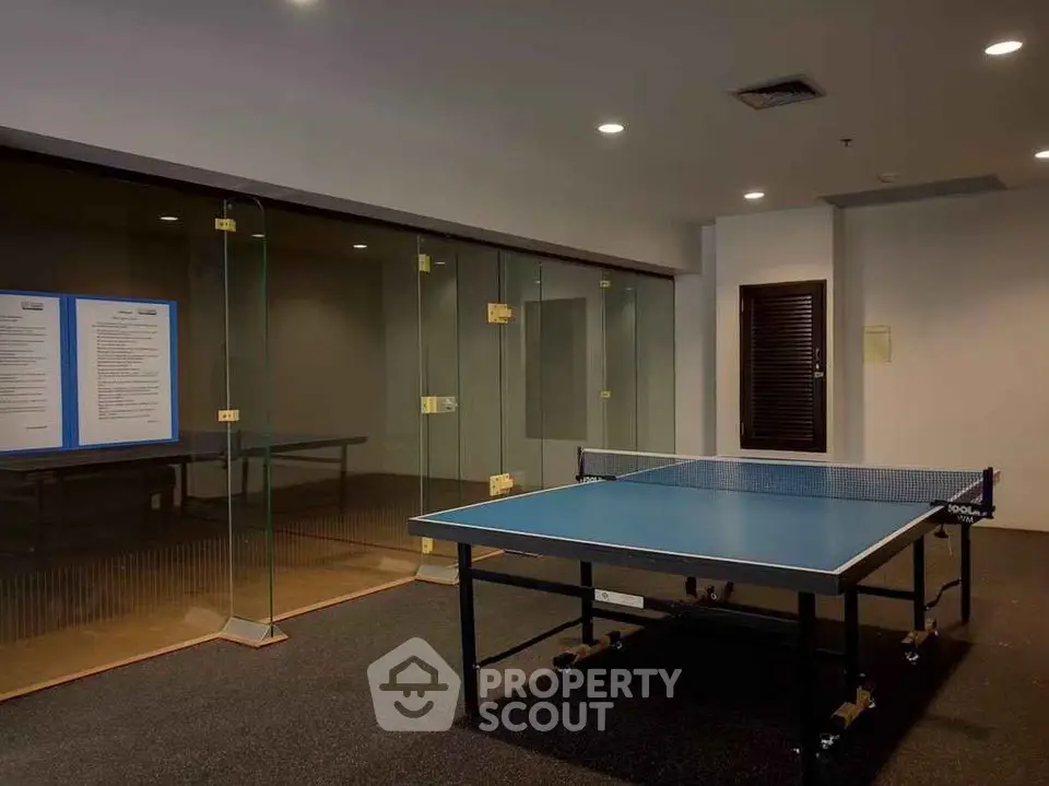 Modern indoor recreational area with table tennis setup in a residential building.