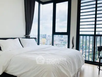 Luxurious bedroom with panoramic city view and large windows in a high-rise apartment.