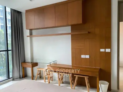 Modern bedroom with stylish wooden furniture and large window view