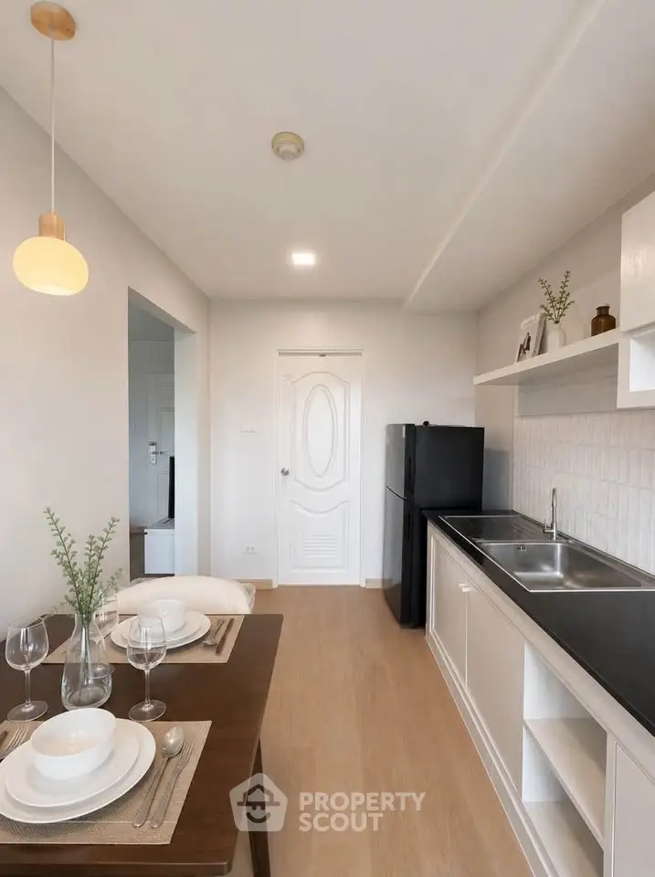Modern kitchen with sleek design and dining area in a stylish apartment