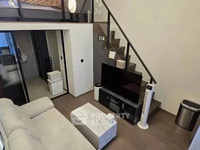 Modern duplex living room with sleek staircase and stylish furniture