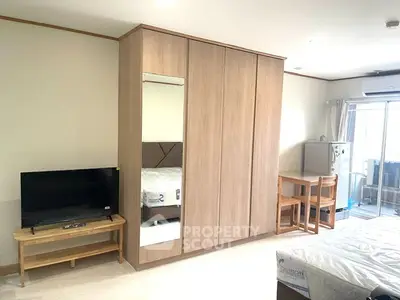 Spacious bedroom with modern wardrobe and balcony access