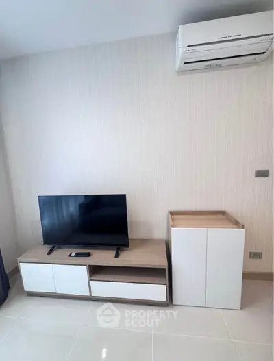 Modern living room with sleek TV stand and air conditioning unit, perfect for comfortable living.