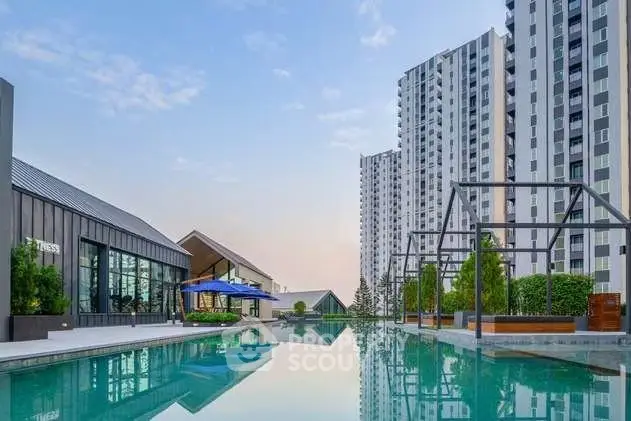 Luxurious high-rise apartment complex with stunning pool and modern amenities.