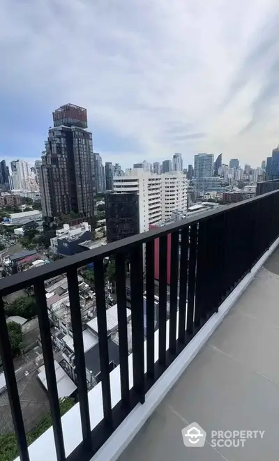 Stunning cityscape view from high-rise balcony with modern railing