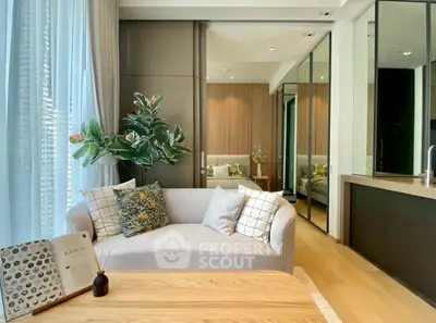 Modern living room with elegant decor and natural light, featuring a cozy sofa and stylish wooden accents.