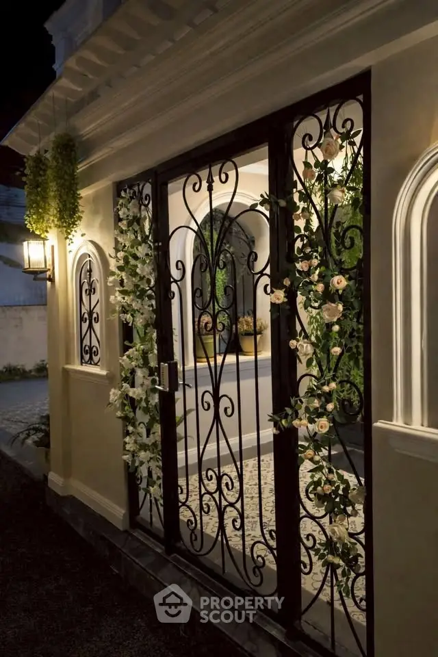 Elegant entrance with ornate wrought iron gate and floral accents, perfect for luxury homes.