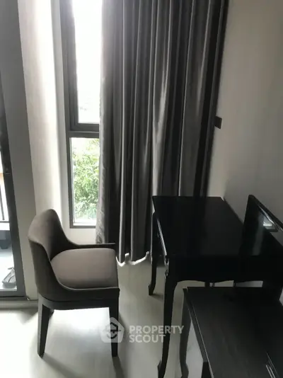 Cozy study nook with elegant chair and desk by a bright window, perfect for productivity.