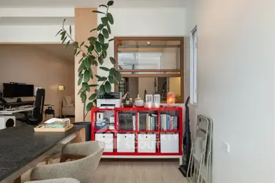 Modern living space with stylish red shelving and cozy seating area