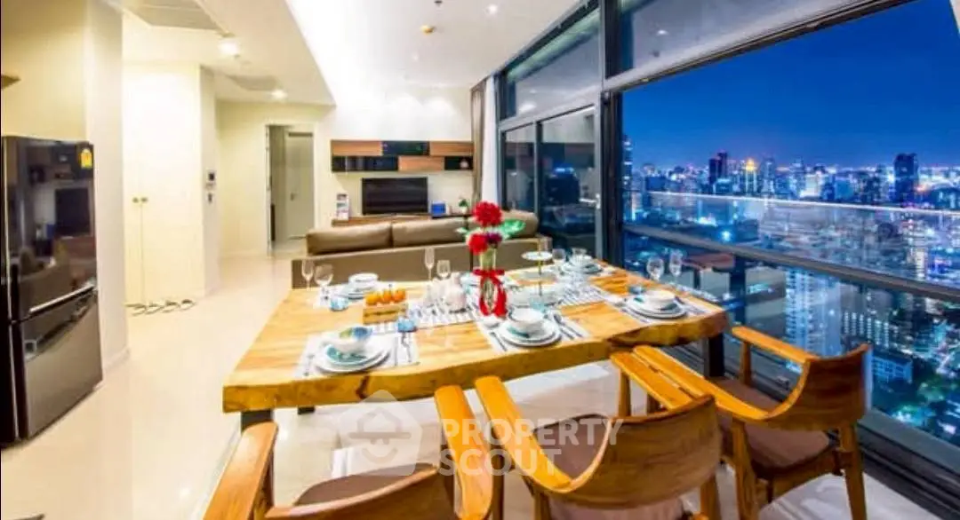 Luxurious open-plan living room with stunning city view and elegant dining setup.