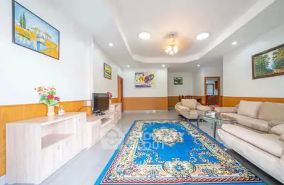 Spacious living room with elegant decor and plush seating