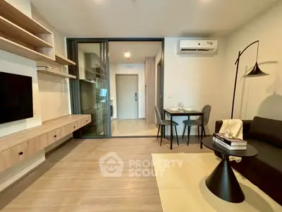 Modern living room with sleek furniture and open layout, featuring a cozy dining area and stylish decor.