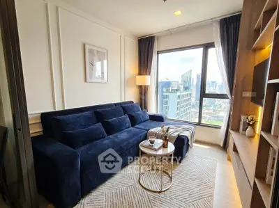 Chic modern living room with city view, featuring a plush navy sofa and elegant decor.