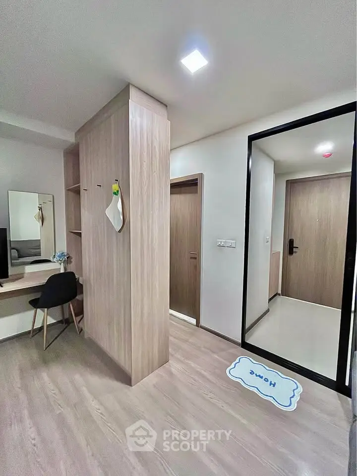 Modern apartment entrance with stylish wooden flooring and sleek interior design