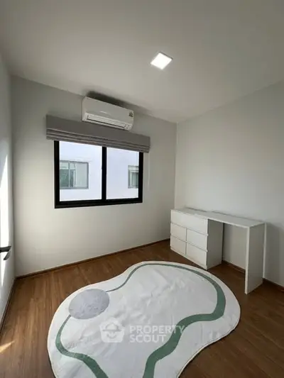 Minimalist bedroom with modern air conditioning and stylish rug