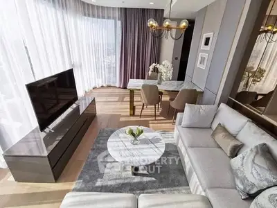 Luxurious modern living room with elegant decor and large windows offering natural light.