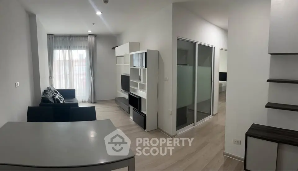 Modern living room with sleek furniture and natural light in a contemporary apartment.