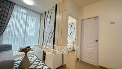Modern living room with stylish decor and natural light in a contemporary apartment.