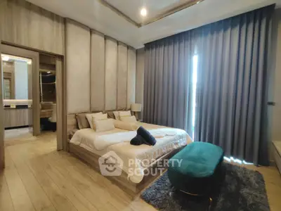 Luxurious bedroom with elegant decor, large window, and plush furnishings for a serene living experience.