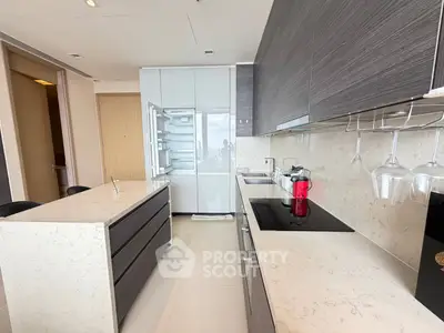 Modern kitchen with sleek cabinetry and island in luxury apartment