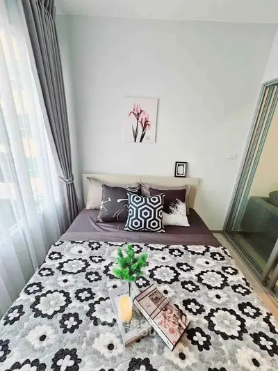 Cozy bedroom with stylish decor and natural light, perfect for relaxation and comfort.