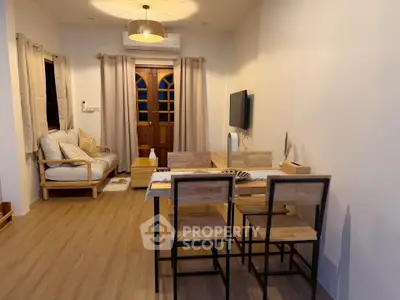 Charming living room with cozy dining area and stylish decor, perfect for modern living.