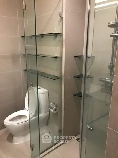 Modern bathroom with glass shower and sleek shelving