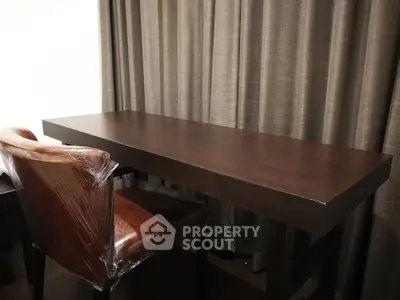 Elegant study area with dark wood desk and leather chair, perfect for productivity.