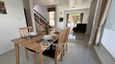 Spacious open-plan living and dining area with modern decor and natural light.