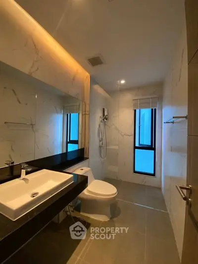 Modern bathroom with sleek fixtures and marble accents