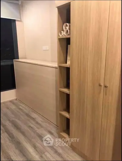 Modern storage solution with wooden cabinets and shelves in a cozy room.