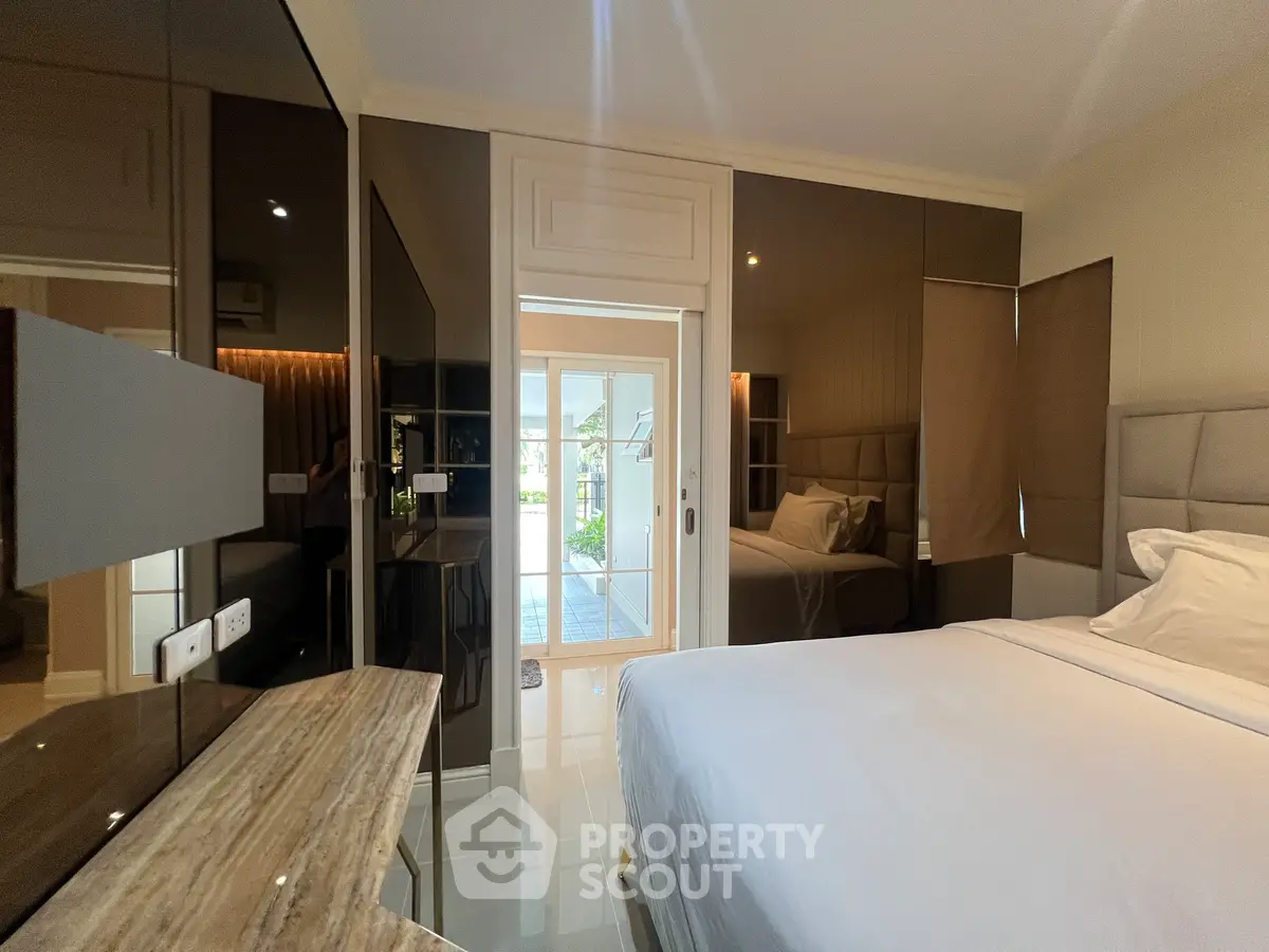 Luxurious bedroom with elegant decor and large windows for natural light.