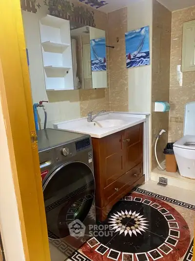 Charming bathroom with modern washer and elegant tile design