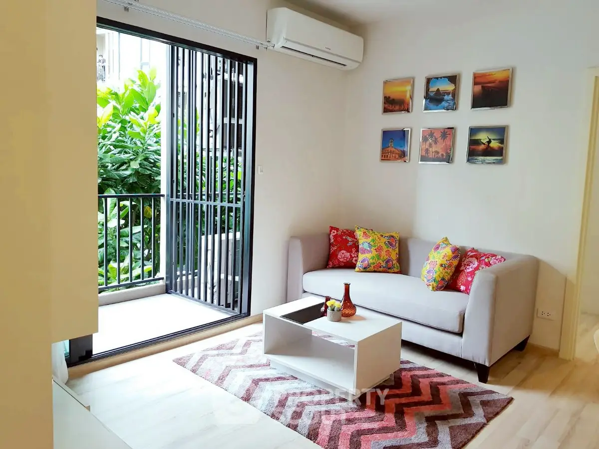 Charming living room with vibrant decor and garden view balcony