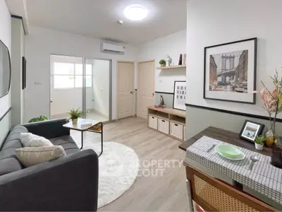 Modern living room with stylish decor and dining area, featuring cozy seating and contemporary artwork.