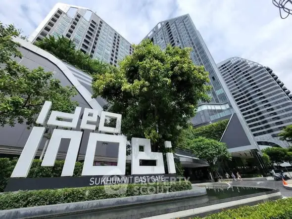 Modern high-rise condominium with lush greenery at Ideo Sukhumvit East Gate.
